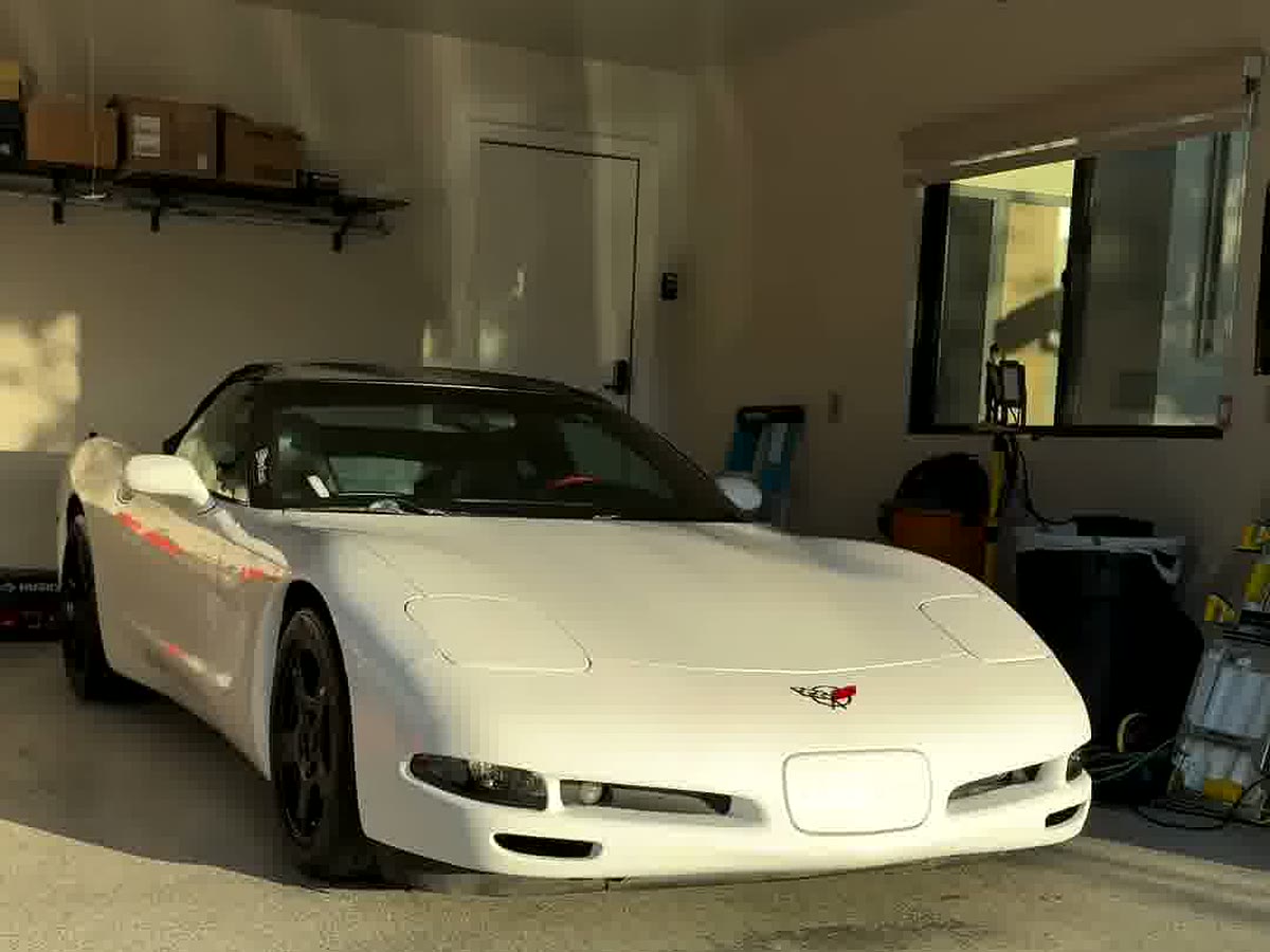 A finished white Corvette back in the shop after a full detail